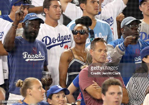 Former Olympian Carmelita Jeter and her father attend The Los Angeles Dodgers Game at Dodger Stadium on July 24, 2019 in Los Angeles, California.