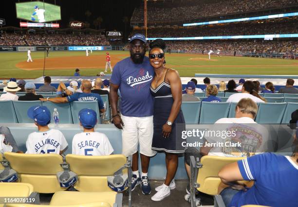 Former Olympian Carmelita Jeter and her father attend The Los Angeles Dodgers Game at Dodger Stadium on July 24, 2019 in Los Angeles, California.