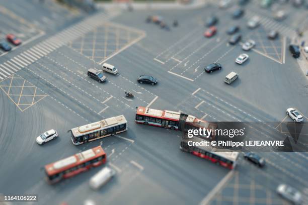 bus and car traffic on a crossroad - tilt shift stock pictures, royalty-free photos & images