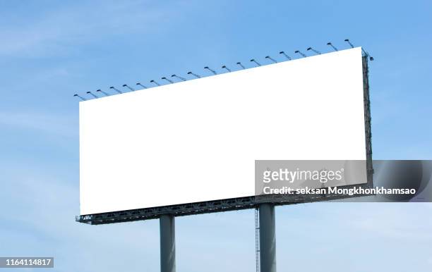 low angle view of billboard against clear blue sky - commercial sign fotografías e imágenes de stock