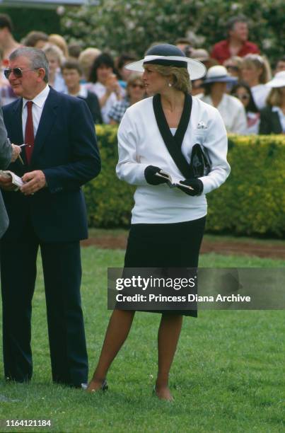 Princess Diana at Flemington race course in Melbourne, Australia, 5th November 1985. She is wearing a suit by Bruce Oldfield and a hat by Frederick...