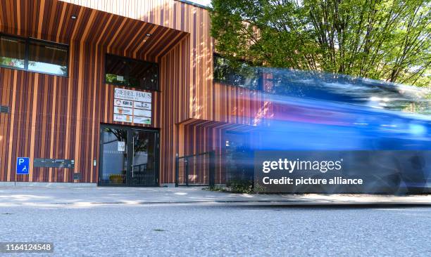 August 2019, Baden-Wuerttemberg, Stuttgart: A car drives past the Giebel children's and youth centre. Here a temporary play street will be set up in...