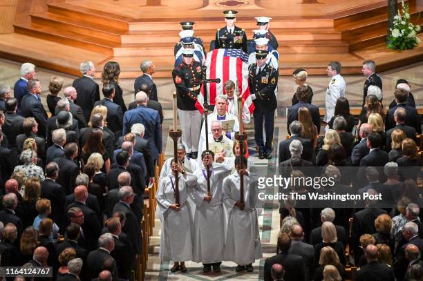 Presidents Bill Clinton, George Bush and Barack Obama look on with the family as the casket is taken out following the funeral service at the...