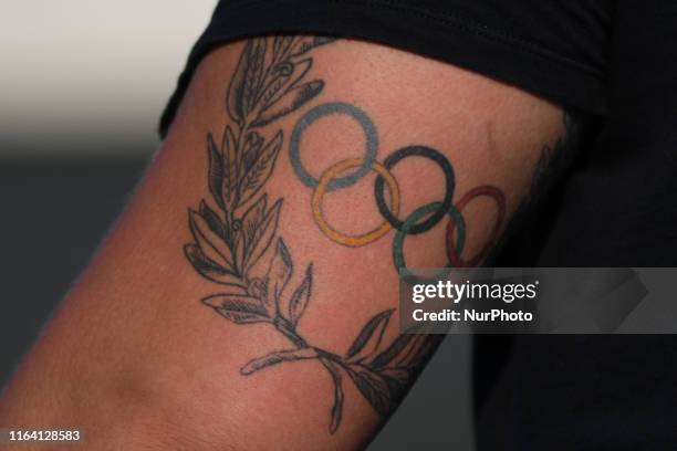 Tatoo with the 'Olympic rings' seen on Konrad Bukowiecki's arm during men's Shot put final, on the third day of the 95th Polish Track and Field...