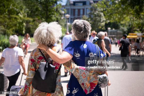 silver haired women touring park in amsterdam - elderly woman from behind stock pictures, royalty-free photos & images