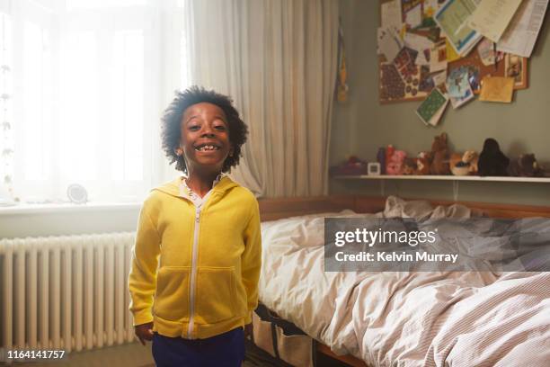 Boy getting dressed in the morning in his bedroom