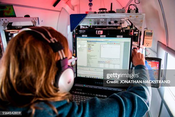 Ian Fenty, co-investigator with Oceans Melting Greenland, or OMG, receives signals from the dropped 1.5-metre cylindrical probes onboard the refitted...