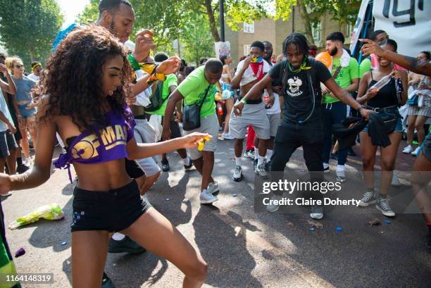 Party goers dancing at the Notting Hill Carnival, on 25th August, 2019 in London, United Kingdom. One million people are expected on the streets in...