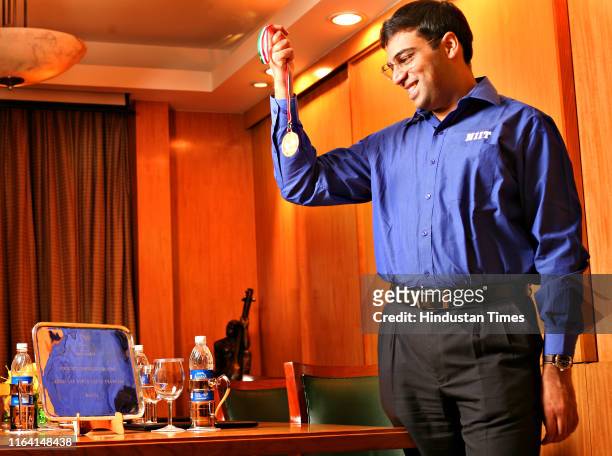 World chess champion Vishwanathan Anand poses with his medal, on October 16, 2007 in New Delhi, India. Anand became the World Chess Champion on Sept....