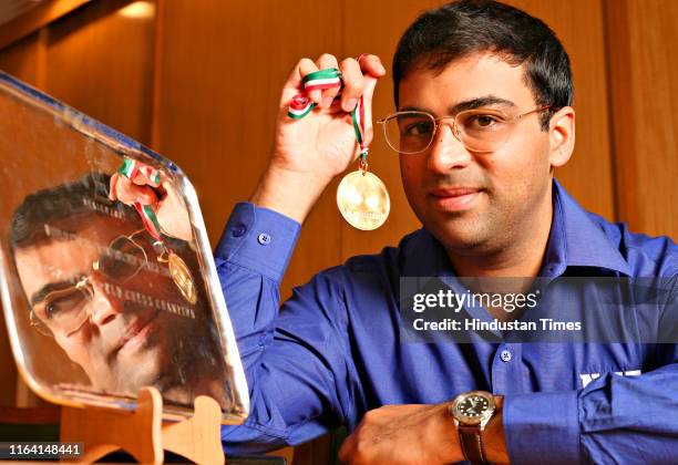 World chess champion Vishwanathan Anand poses with his medal, on October 16, 2007 in New Delhi, India. Anand became the World Chess Champion on Sept....