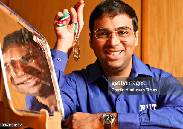 World chess champion Vishwanathan Anand poses with his medal, on October 16, 2007 in New Delhi, India. Anand became the World Chess Champion on Sept....