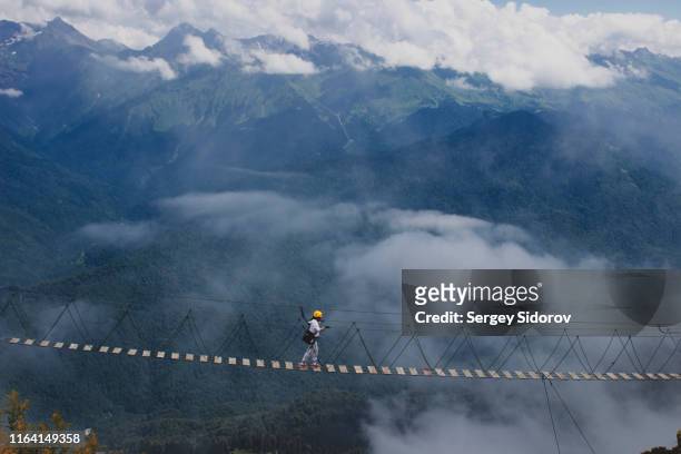 extreme sporten in de bergen - touwbrug stockfoto's en -beelden