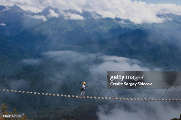 extreme sports in the mountains - scary rope bridge stock pictures, royalty-free photos & images