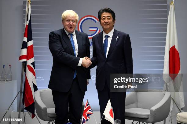 Britain's Prime Minister Boris Johnson meets Japanese Prime Minister Shinzo Abe for their bilateral talks during the G7 Summit on August 26, 2019 in...