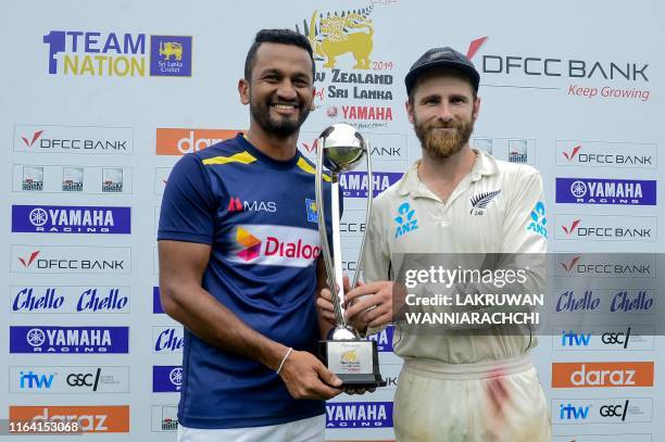 Sri Lanka's cricket team captain Dimuth Karunaratne and New Zealand's cricket team captain Kane Williamson hold the trophy during the presentation...
