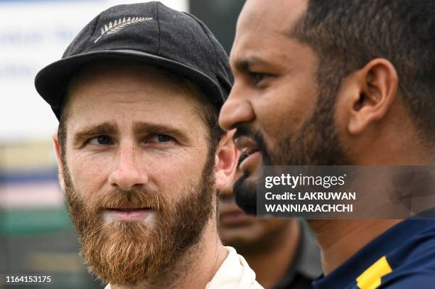 Zealand's cricket team captain Kane Williamson interacts with Sri Lanka's cricket team captain Dimuth Karunaratne during the presentation ceremony on...