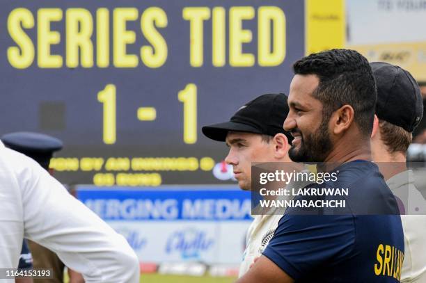 Sri Lanka's cricket team captain Dimuth Karunaratne and New Zealand's cricketer Tom Latham look on during the presentation ceremony on the final day...