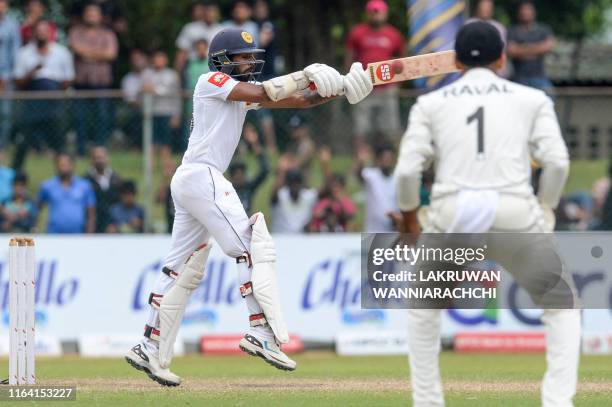 Sri Lanka's cricketer Niroshan Dickwella plays a shot during the final day of the final cricket Test match between Sri Lanka and New Zealand at P....