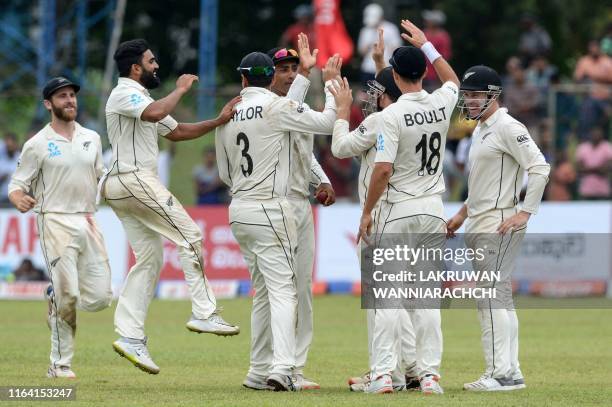 New Zealand's cricketers celebrate after the dismissal of Sri Lanka's cricketer Niroshan Dickwella during the final day of the final cricket Test...