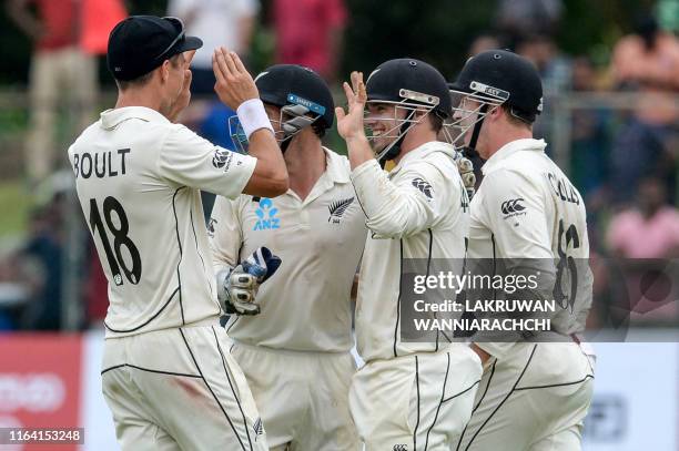 New Zealand's cricketers celebrate after the dismissal of Sri Lanka's cricketer Niroshan Dickwella during the final day of the final cricket Test...