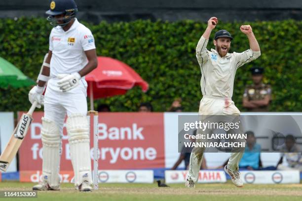 New Zealand's cricket captain Kane Williamson takes a catch to dismiss Sri Lanka's cricketer Lasith Embuldeniya during the final day of the final...