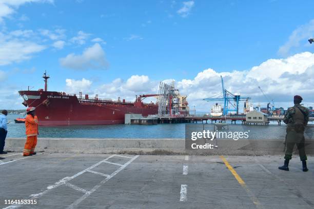 Security officer stand at the berth of an oil tanker carrying 200,000 barrels of crude oil worth Ksh 1.2 billion during the inaugural shipment of...