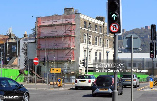 Brexit-themed Banksy mural in Dover that has been mysteriously covered up with white paint and scaffolding. The artwork appeared on a former...