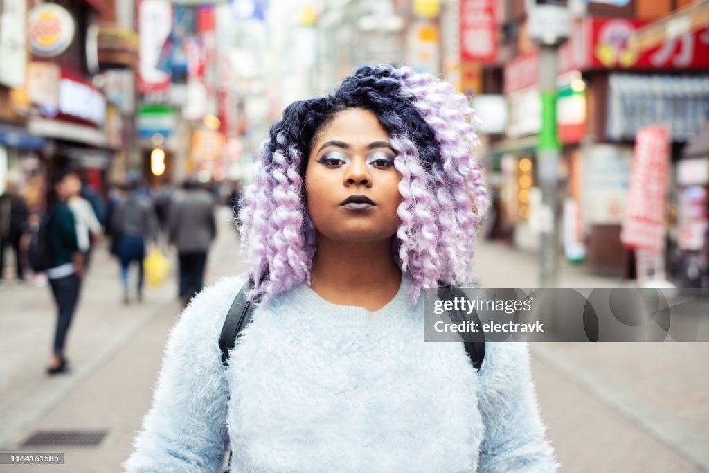 Street portrait of young woman with purple hair