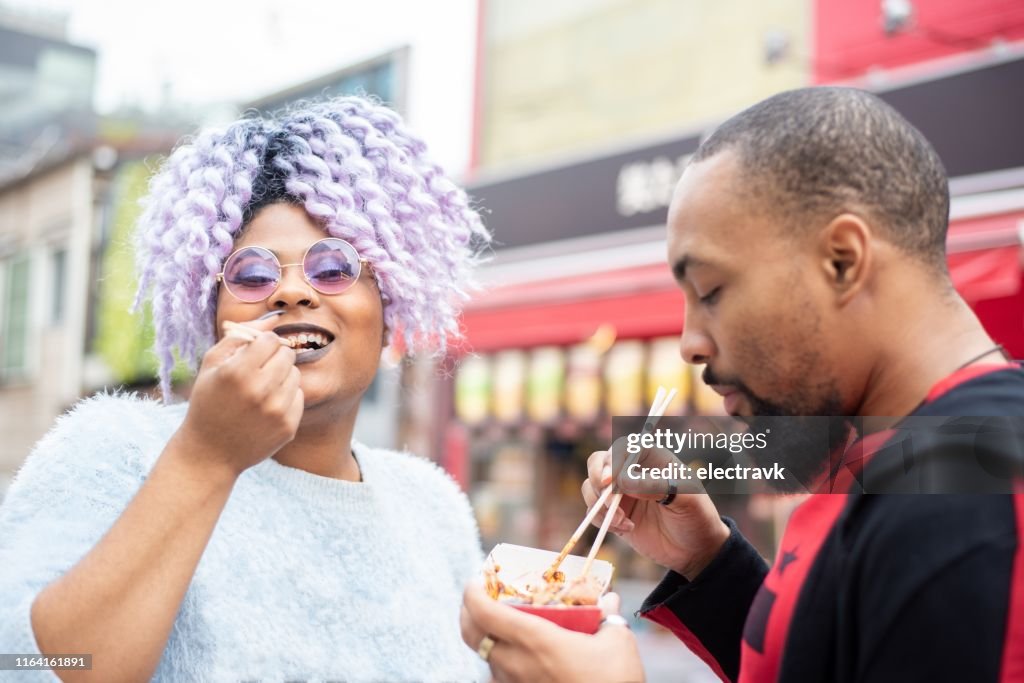 Millennial travellers trying local delicacies