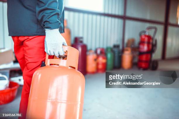 gas cylinder lined up to be filled in store - red tube stock pictures, royalty-free photos & images