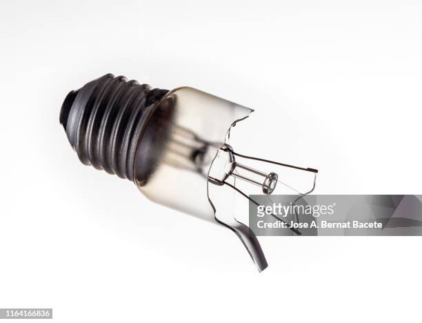 close-up of light bulb broken against white background. - broken lamp stockfoto's en -beelden