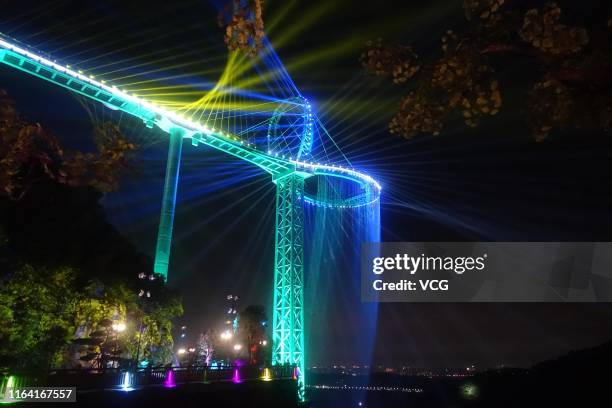 Aerial view of a circular glass bridge at the Huangtengxia tourist attraction on July 23, 2019 in Qingyuan, Guangdong Province of China. Dozens of...