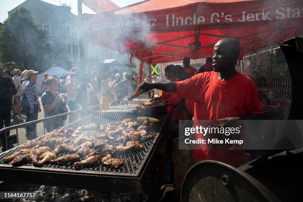 Jerk chicken cook at Notting Hill Carnival on 25th August 2019 in West London, United Kingdom. A celebration of West Indian / Caribbean culture and...