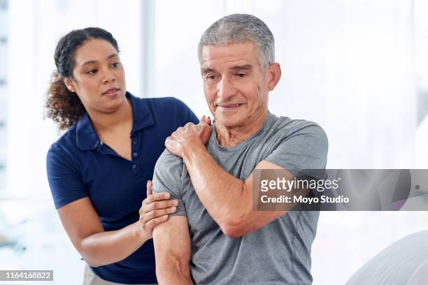 the pain is right on this spot doc - physiotherapy shoulder stock pictures, royalty-free photos & images