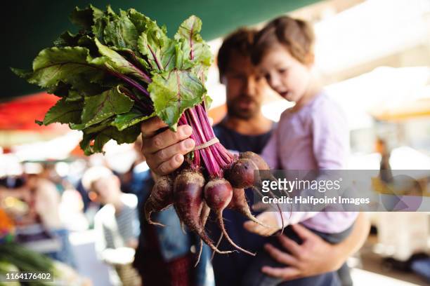 a family with children buying vegetables on outdoor market in mediterranean town. - fruit market stock pictures, royalty-free photos & images