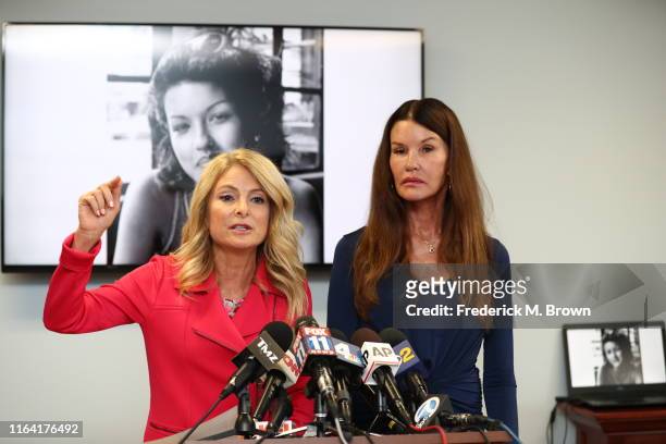 Attorney Lisa Bloom and Janice Dickinson speak during a press conference to announce a settlement in their defamation lawsuit against Bill Cosby at...
