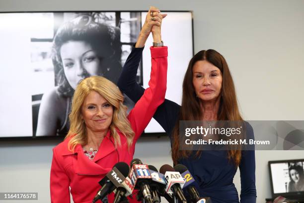 Attorney Lisa Bloom and Janice Dickinson speak during a press conference to announce a settlement in their defamation lawsuit against Bill Cosby at...