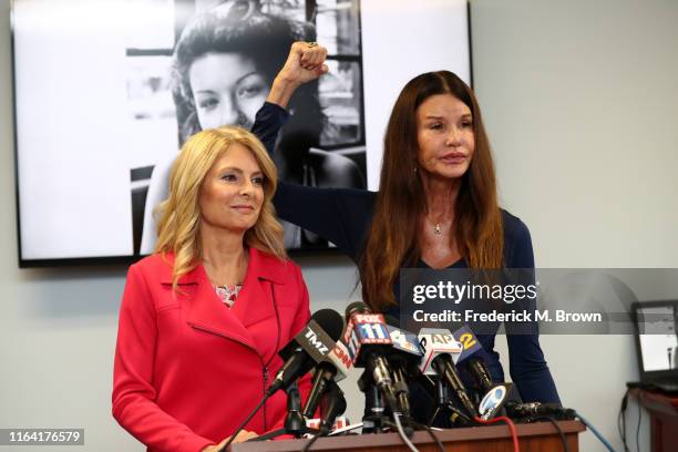 Attorney Lisa Bloom and Janice Dickinson speak during a press conference to announce a settlement in their defamation lawsuit against Bill Cosby at...