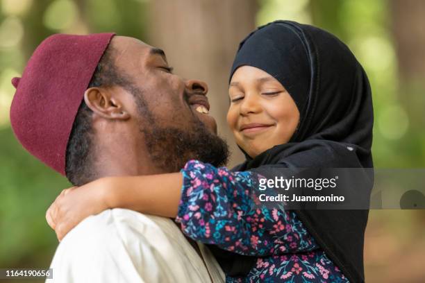 muslim father and daughter at her first day of school - islam stock pictures, royalty-free photos & images