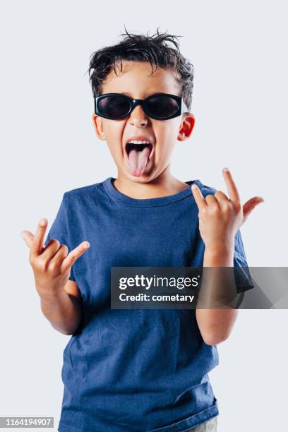 little bıy shows gesture "that rock'' - little punk stock pictures, royalty-free photos & images