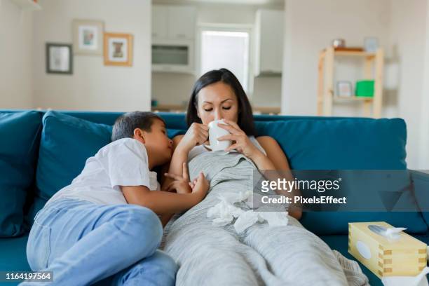 son taking care of his sick mother - patient protection and affordable care act stock pictures, royalty-free photos & images