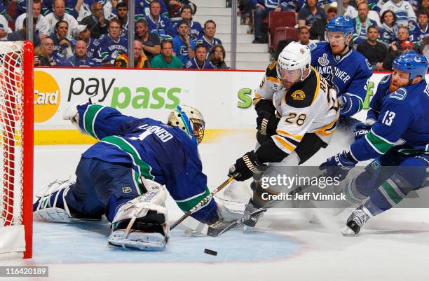 Roberto Luongo of the Vancouver Canucks makes a save on Mark Recchi of the Boston Bruins during Game Seven of 2011 NHL Stanley Cup Final between the...