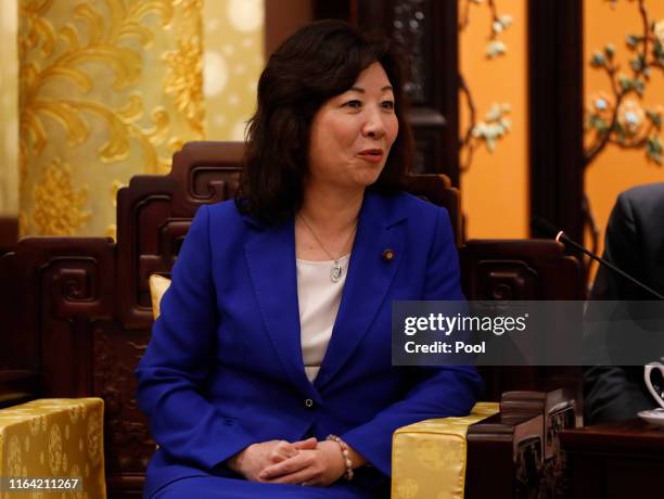 Seiko Noda, team leader of the China-Japan Friendship female parliament members delegation speaks to Chinese Foreign Minister Wang Yi at the...