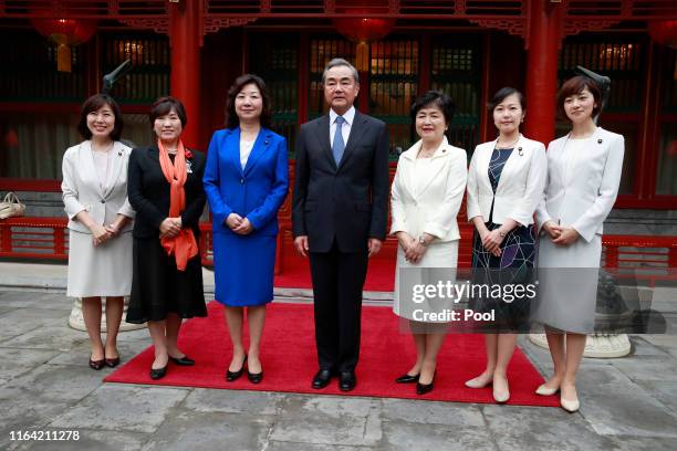 Chinese Foreign Minister Wang Yi pose for a group photo with Seiko Noda , team leader and other members of the China-Japan Friendship female...
