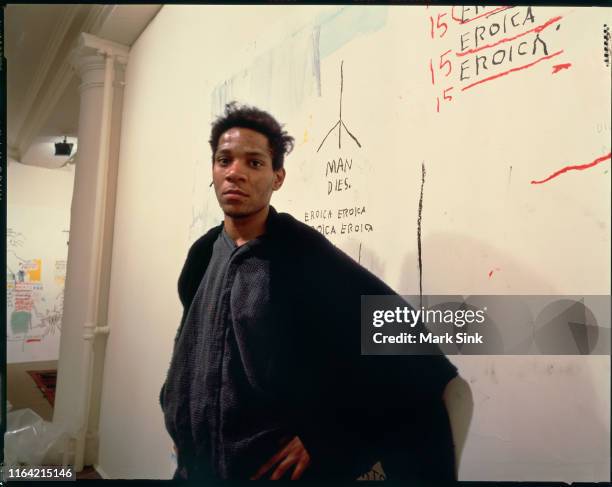 New York City, NY Jean-Michel Basquiat stands in front of his painting with the words " Man Dies " on exhibit at the Vreg Baghomian Gallery shortly...