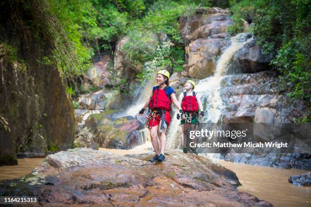 canyoning is one of the most popular activities in dalat. these girls explore the river rapids. - canyoning bildbanksfoton och bilder