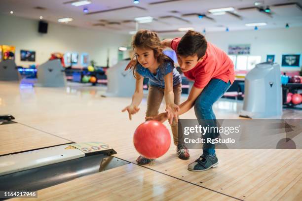 sister and brother bowling - bowling alley stock pictures, royalty-free photos & images