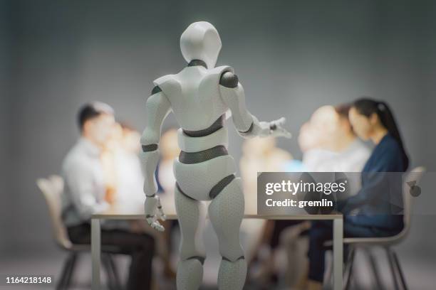 humanoid robots teaching business people in the office - android stock pictures, royalty-free photos & images