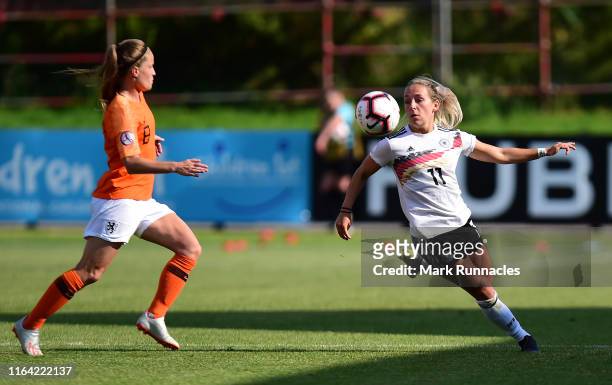 Gina-Marie Chimielinski of Germany challenges Marisa Ollslager during the UEFA Women's U-19 European Championship Semi Final match between...