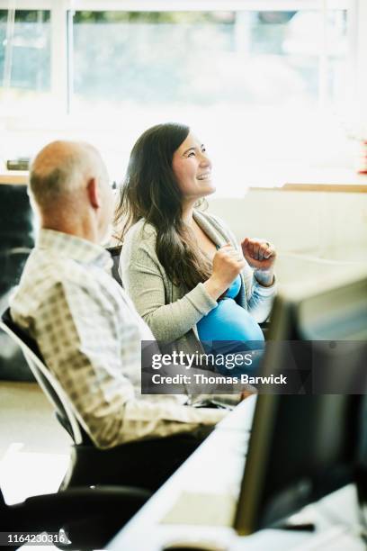 Premium AI Image  a pregnant woman sitting in an office chair